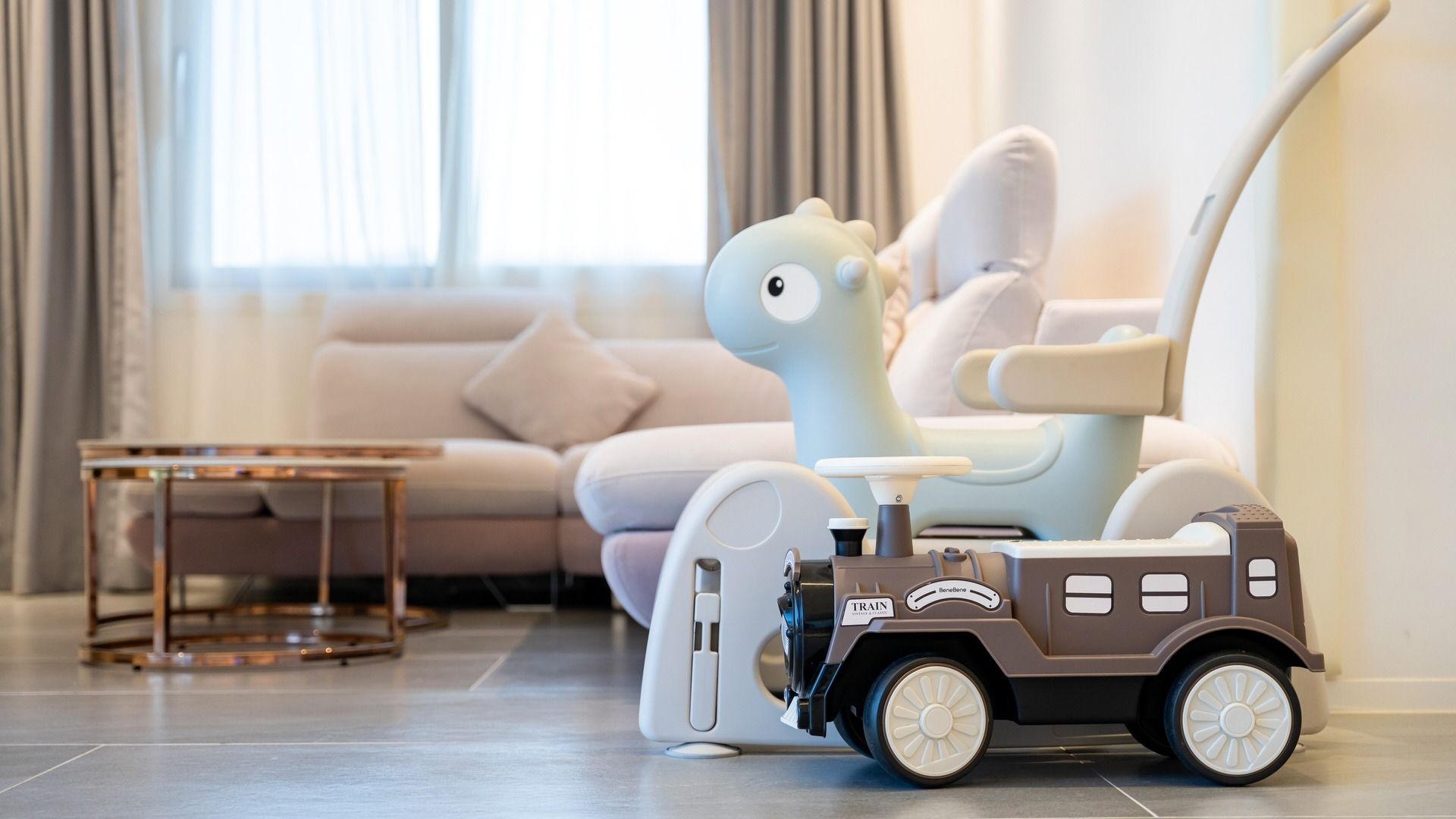A modern living room with a sofa, a coffee table, and a toy car.