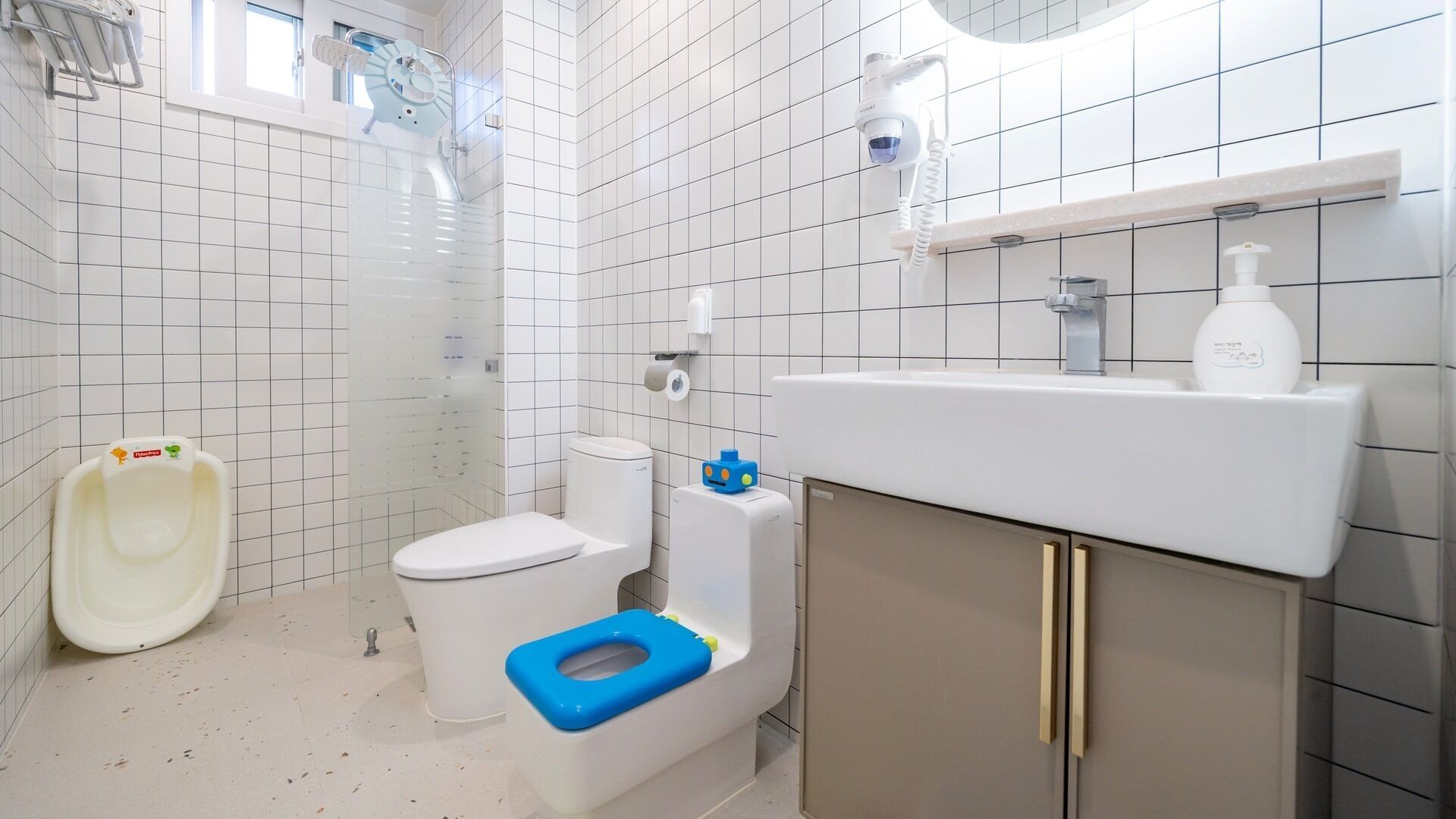 A modern bathroom with a toilet, bidet, and sink.