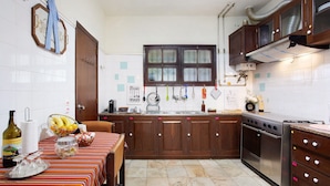 A kitchen with wooden cabinets, a stainless steel stove, and a tiled backsplash.