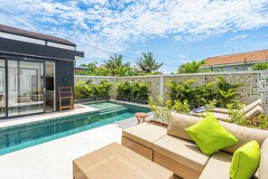 A modern outdoor pool area with a built-in seating area and a view of the surrounding neighborhood. - Terrace B3 Villa by Betterplace (Canggu)