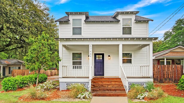 A two-story house with a front porch, a blue door, and a number '5748' on the wall. - Near Park Circle, Downtown, & Beaches | Pool Table (Hanahan)