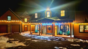 A two-story house with a covered porch, a garage, and a front yard with snow. - New Luxuary Hunter Ski Resort&Lake Chalet, Hot Tub, Sauna, Fireplace, Mountains (Hunter)