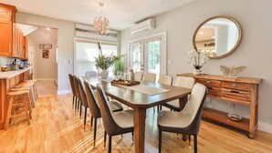 A spacious dining area with a long wooden table, multiple chairs, and a central plant. - New Luxuary Hunter Ski Resort&Lake Chalet, Hot Tub, Sauna, Fireplace, Mountains (Hunter)