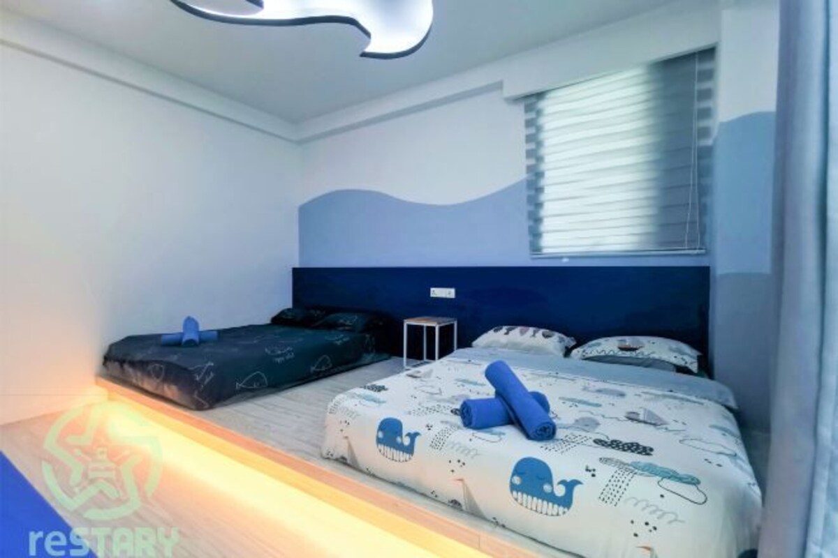 A bedroom with a bed, two side tables, a window with blinds, and a unique ceiling light fixture.