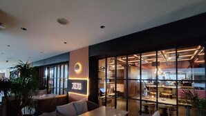 A modern restaurant interior with a bar area, seating arrangements, and a visible menu board. - reStary Blue Game Themed Homestay (Kota Kinabalu)