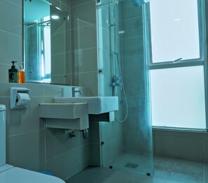 A modern bathroom with a sink, mirror, and shower. - reStary Blue Game Themed Homestay (Kota Kinabalu)