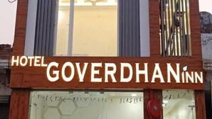 A modern hotel with a prominent sign reading "HOTEL GOVERDHAN INN". - Hotel Govardhan Inn (Mathura)