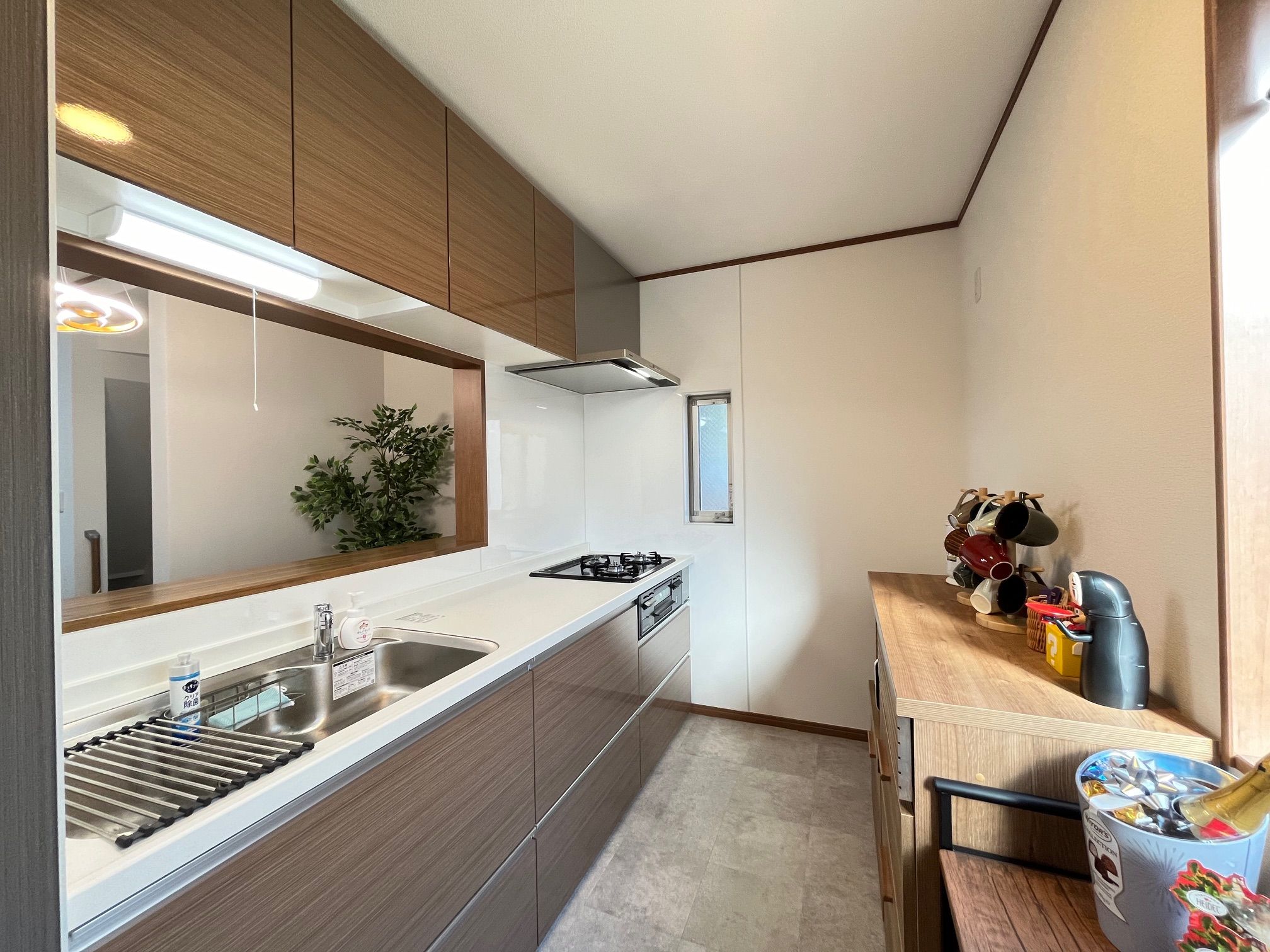 A compact kitchen with a built-in stove, sink, and wooden cabinets.