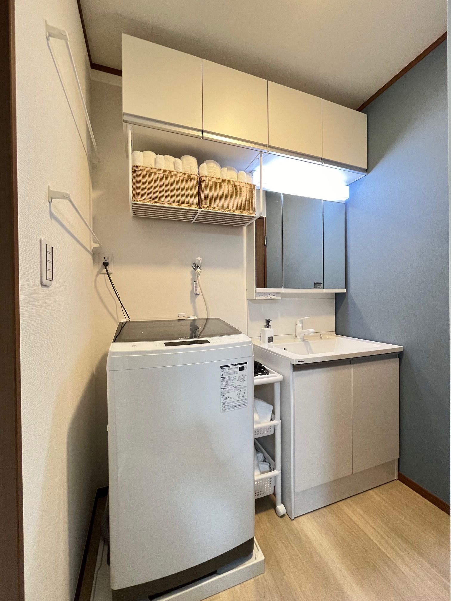 A compact kitchenette with a built-in refrigerator, a sink, and a microwave.