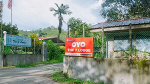 A sign for 'The 7 Lodge' with a contact number and an app download prompt. - Hotel O The 7 Lodge Tambunan (Tambunan)