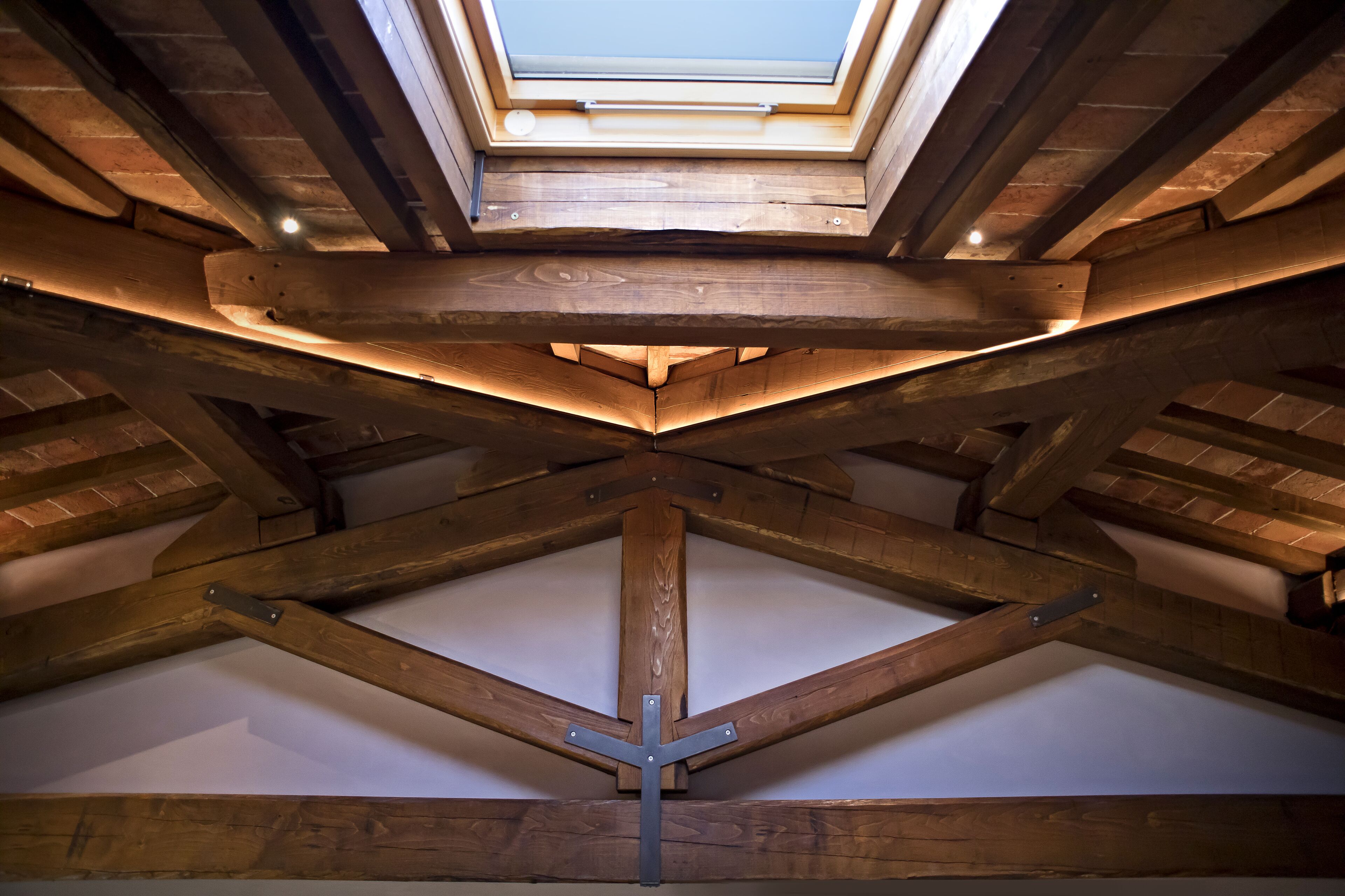 A skylight in a wooden ceiling structure.