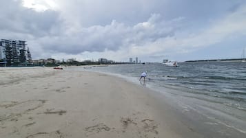 Guests can enjoy a serene beach scene with a sandy shore and calm sea.
