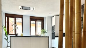 A modern reception area with a marble floor, a reception desk, and a large window with blinds. - Casa con Jacuzzi y Piscina con Vistas al Castillo (Corbera)