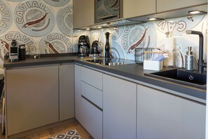Fridge, stovetop, dishwasher, coffee/tea maker