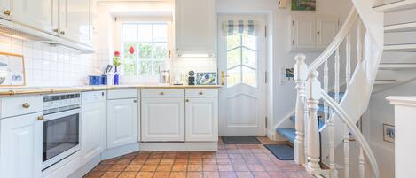 Fridge, stovetop, dishwasher, coffee/tea maker