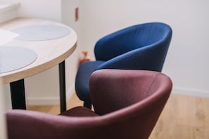 A cozy space with a round table and a comfortable chair.