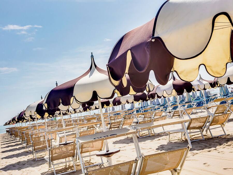 On the beach, white sand, sun loungers, beach umbrellas
