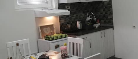 Fridge, stovetop, cookware/dishes/utensils, dining tables