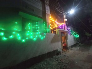 Adorned with twinkling string lights, this charming building's entrance invites you in.