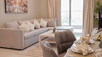 Deluxe Apartment, 2 Bedrooms | Living area | 55-inch Smart TV with satellite channels