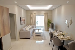 Deluxe Apartment, 2 Bedrooms | Living area | 55-inch Smart TV with satellite channels