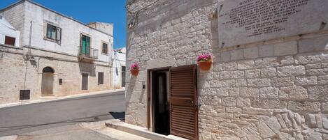 A stone building with a plaque and a wooden door.