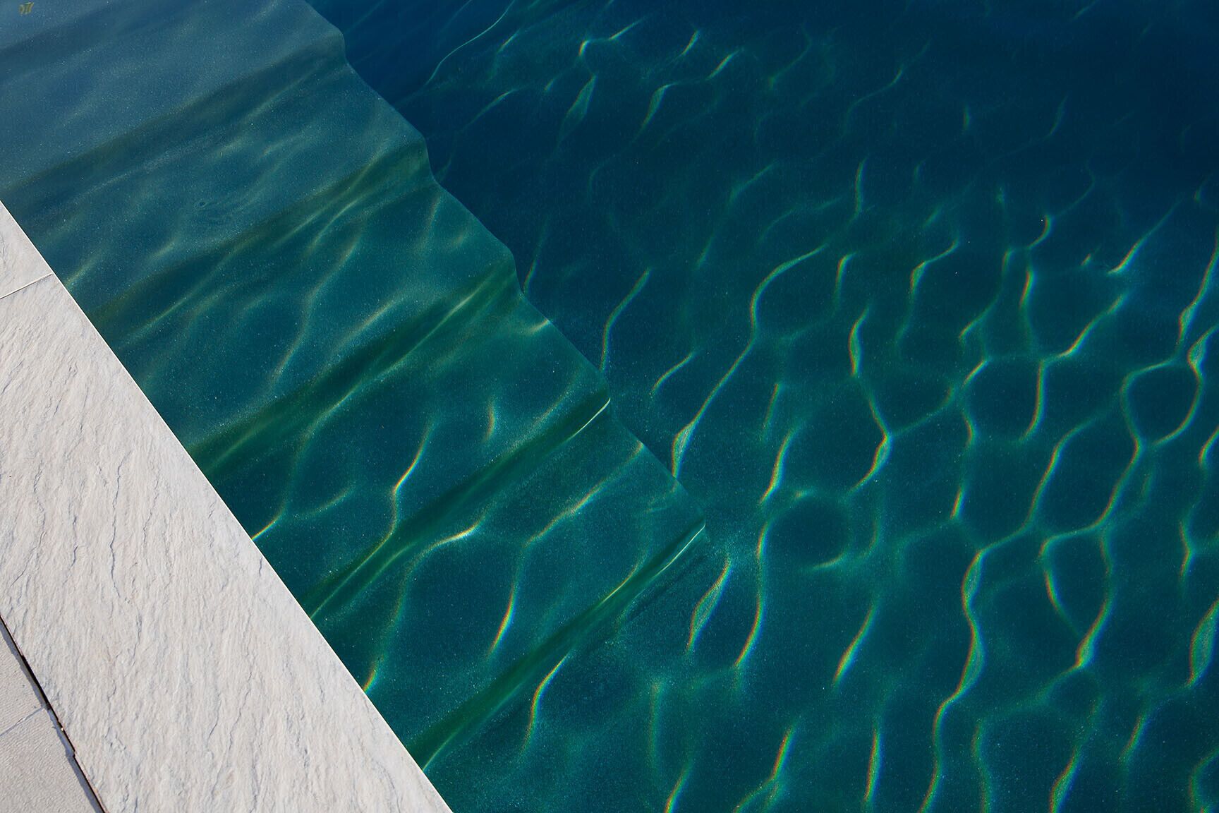 A pool with clear water and visible ripples.