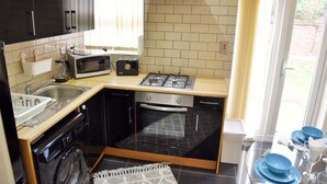 A compact kitchen with a microwave, toaster, stove, oven, and dishwasher. - Luxury Duplex Apartment (Bedford)