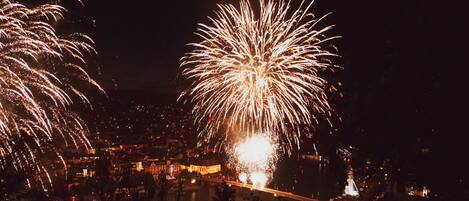 A nighttime view of a city with fireworks display.