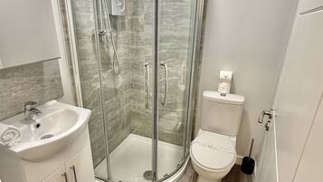 Shower, hair dryer, towels, toilet paper