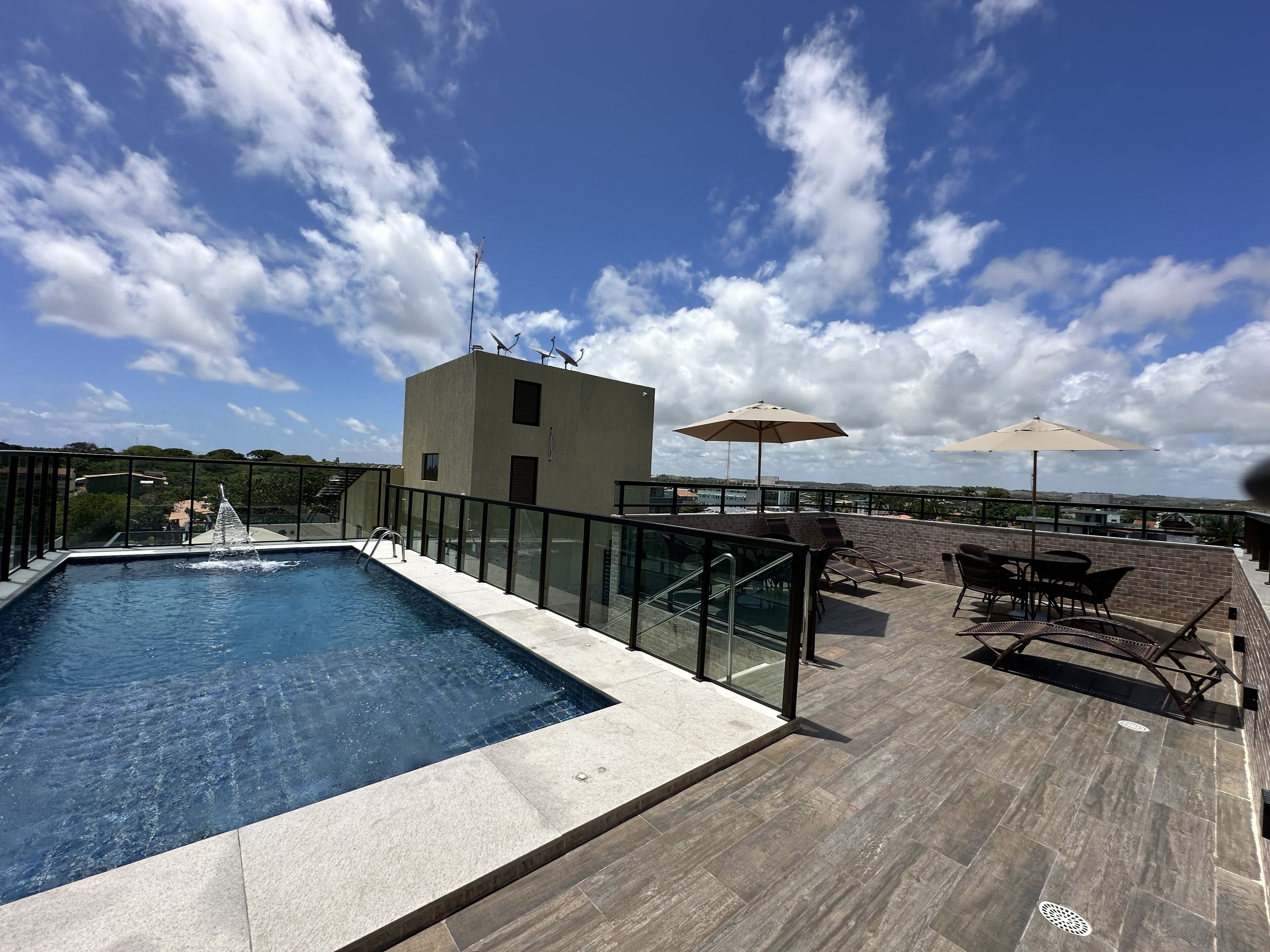 A rooftop pool with a clear view of the surrounding buildings and sky.