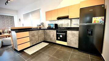 Fridge, microwave, electric kettle, cookware/dishes/utensils