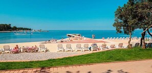 Relax on the beach with access to the sea and comfortable sun loungers.