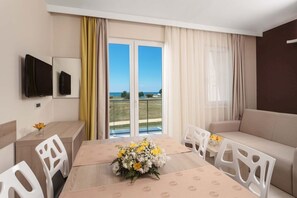 Enjoy a comfortable stay with a flat-screen TV, sofa, and dining table in this stylish room.