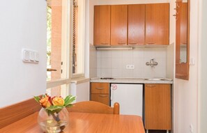 Fridge, stovetop, high chair, cookware/dishes/utensils