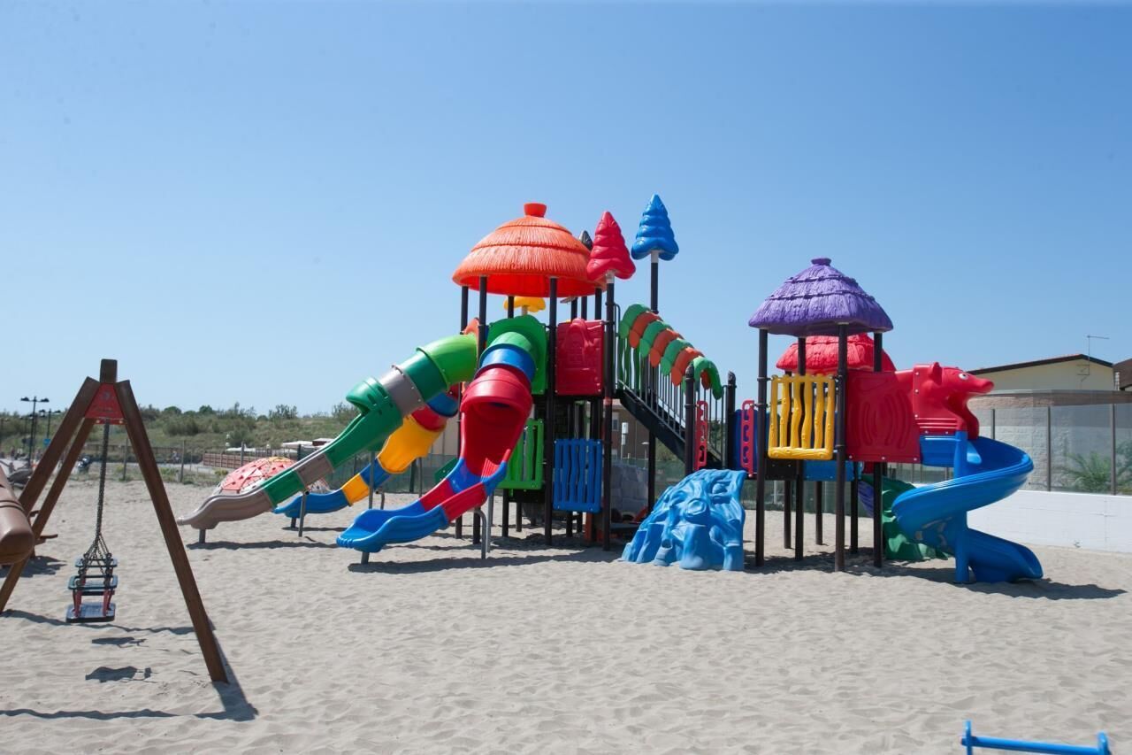 A playground with multiple slides and climbing structures.