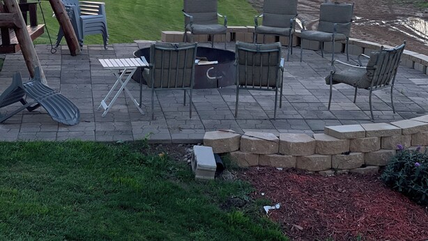 An outdoor patio with a fire pit, seating area, and a view of the sunset over a forested landscape. - Ranch get away (Merrill)