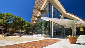 A modern building with a sloped roof and large glass windows. - Vacation complex Stella Apartment Premium PA2TP2 for 4 persons (Umag)