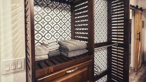 A bunk bed with a patterned wall and a wooden drawer unit. - French Cottage Studio • Dog-Friendly • Near Amelia Island (Fernandina Beach)