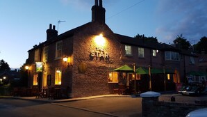 A stone building with a sign reading "The Star" at dusk. - The Star Inn (Driffield)