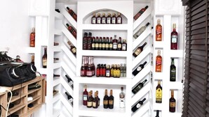 A wine cellar with multiple shelves and racks for storing bottles. - Joyrich Hotel (Epe)