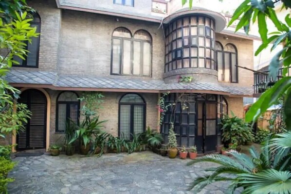 Stunning two-story building with a covered entrance and a charming balcony.