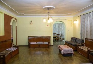 Relax in this classic living room with a sofa, armchair, and small table.