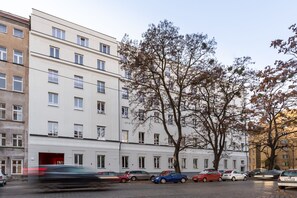 A row of multi-story buildings with parked cars and trees. - MILESTONE Wrocław Ołbin by Tribera (Wroclaw)