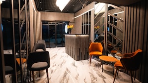 A modern interior with a reception desk, seating area, and a staircase. - Cip hotel istanbul  (Istanbul)