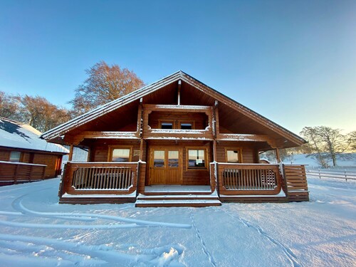 A traditional Scandinavian style lodge, with stylish wooden interior decorated with a Scottish theme