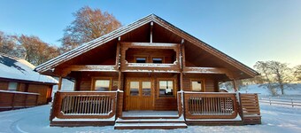 A traditional Scandinavian style lodge, with stylish wooden interior decorated with a Scottish theme
