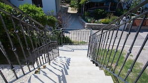 A staircase with metal railings leading to a building entrance.