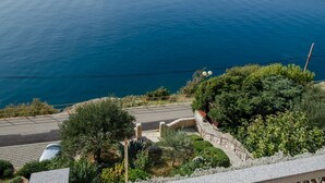 A coastal road with a stone bridge, lush greenery, and a view of the sea. - Directly on the crystal clear Adriatic Sea (Baska)