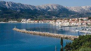 A coastal town with a marina, rocky breakwater, and mountainous backdrop. - Directly on the crystal clear Adriatic Sea (Baska)